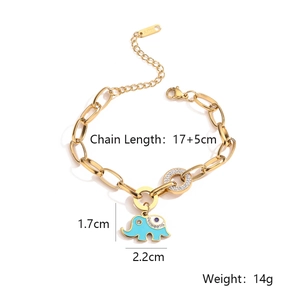 Detail of gold elephant charm with blue enamel and zircon on thick steel chain