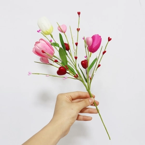Detail of faux pink tulip stems with decorative heart-shaped berries for Valentine's Day