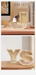 Detail view of J, Y, S letter wooden money box with transparent acrylic panel