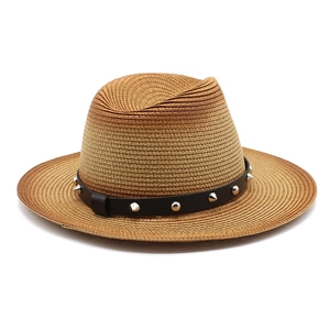 Detailed view of summer straw hat featuring a black leather band and silver metal studs