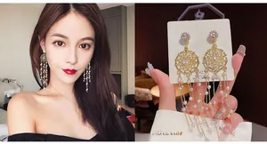 Macro detail of 925 silver needle pearl tassel dreamcatcher earrings with zircon studs