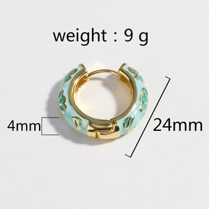 Detail of 24mm gold earrings with light blue enamel flower patterns and size markings