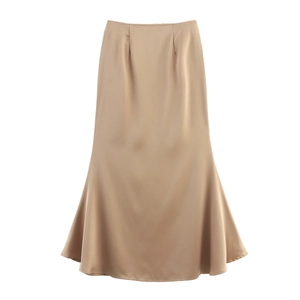 Detail of elegant champagne satin mermaid skirt showing smooth fabric and wavy hem