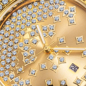 Macro shot of gold watch dial with crystal star patterns and date window display