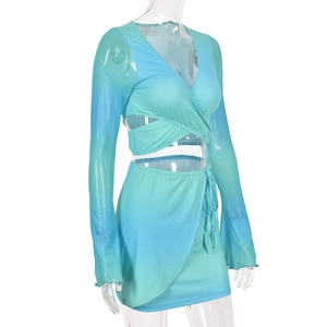 Detail of blue and green gradient two-piece set featuring long mesh sleeves and V-neck