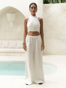 Detailed texture of white linen halter crop top and matching drawstring wide-leg pants