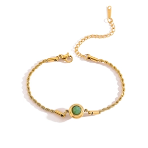 Detail of gold rope chain bracelet with green gemstone, lobster clasp and extension chain