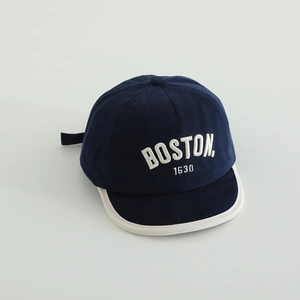 Detailed close-up of navy cotton baby baseball cap featuring white Boston embroidery