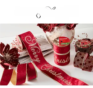 Detail of red velvet Christmas ribbons with gold Merry Christmas lettering and grid patterns