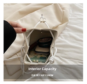 Internal view of white drawstring bucket bag showing space for phone and makeup