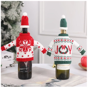 Macro detail of Christmas knitted wine bottle sweater and matching hat with JOY pattern