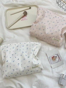 Floral makeup pouch set in pink and cream with blue flower patterns and zipper closure
