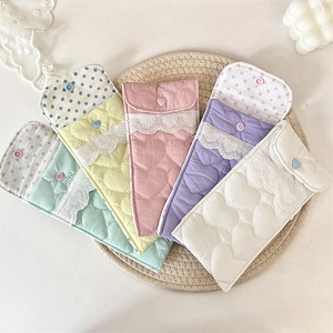 Detailed view of quilted heart pattern sunglasses pouches in five pastel colors