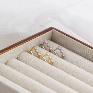 Macro shot of U-shaped S925 sterling silver earrings with row-set sparkling zircon stones