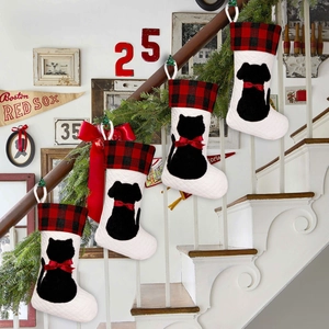 Christmas stockings with red plaid cuff and pet silhouettes hanging on stairs