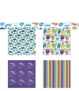 Detail view of four colorful cartoon gift wrapping paper patterns with monster and stripe designs