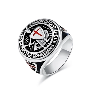 Macro shot of silver Templar shield ring with red cross and Bible verse engraving