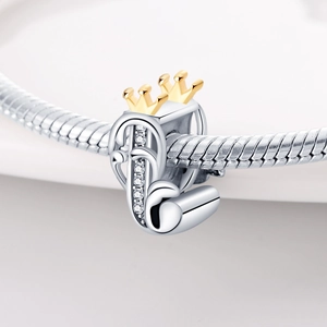 Close-up of silver letter D charm with gold crown and sparkling crystals on snake chain