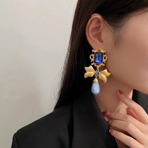 Vintage gold bow earrings with rectangular navy gemstone and light blue teardrop beads
