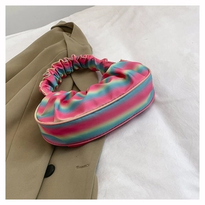 Detailed close-up of rainbow gradient pleated shoulder bag with scrunchie style handle
