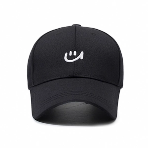 Classic black cotton baseball cap with white smile embroidery and a minimalist casual style