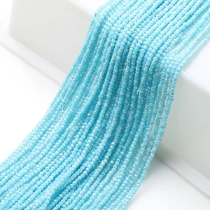 Detail of 2mm sky blue faceted glass beads showing fine multi-faceted cutting and texture