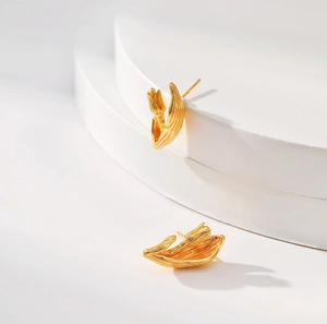 Bohemian style 18K gold plated tulip earrings displayed on a white staircase stand
