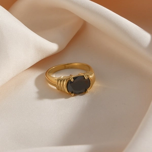 Detail of vintage gold ring featuring a black oval zircon with textured wire pattern