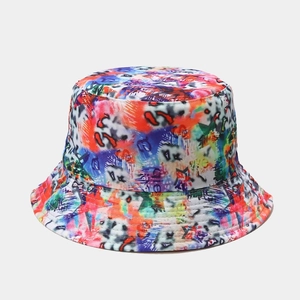 Detail of colorful graffiti print on a reversible canvas bucket hat with street style
