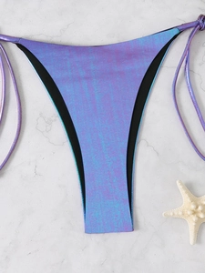Detailed view of shimmering purple and blue metallic bikini bottom with side tie straps