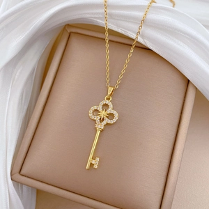 Luxurious star cross key pendant necklace with crystals on brown velvet jewelry display