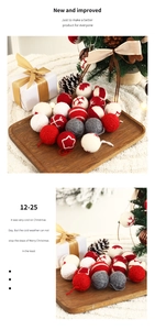 Detailed view of handcrafted wool Christmas balls with snowflake embroidery on wood tray