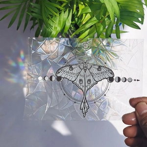 Rainbow suncatcher window film with moth and moon phases showing colorful light effects