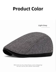 Detail of light gray newsboy cap featuring a vertical knit texture and black brim piping