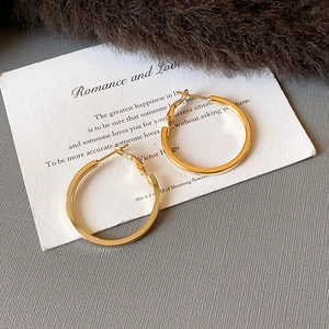 Flat gold geometric pleated hoop earrings with minimalist wide band and latch closure