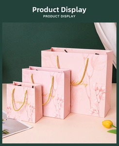 Detailed view of pink gift bags in three sizes with golden Beautiful Day lettering