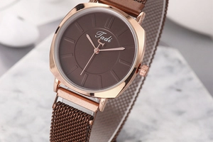 Detail of coffee brown square watch face with rose gold case and magnetic mesh strap