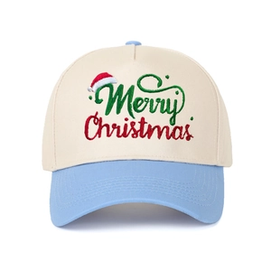 Macro view of Christmas embroidery on the sky blue and beige baseball cap crown