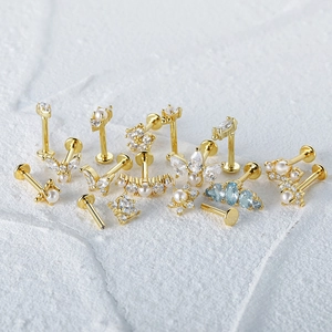Detailed view of S925 sterling silver gold labrets with pearls and blue gemstones