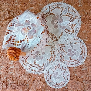 White floral lace coasters and round basket cover with elegant hollow embroidery