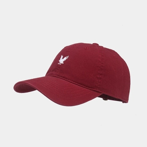 Close-up of eagle embroidery on burgundy cotton baseball cap with high-quality stitching