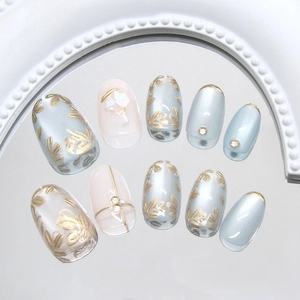 Floral cat-eye press-on nails with gold leaf patterns and pearl accents in 10-piece set