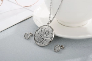Detail of silver hollowed glass mirror jewelry set with tree pattern and crystals