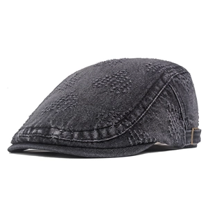 Detail of dark gray washed denim hat showing bronze buckle and leather side strap
