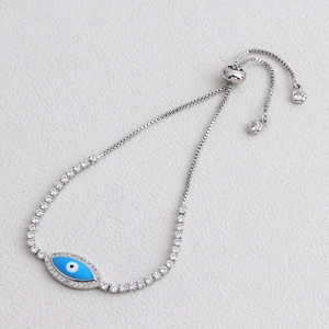 Close-up of sparkling adjustable Evil Eye bracelet with blue enamel and silver-plated chain