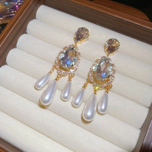 Detail view of vintage water drop pearl earrings with gold plating and zircon crystals