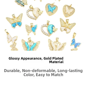 Detailed macro view of gold-plated butterfly pendants with blue opal and zircon stones