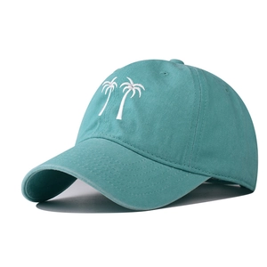 Detailed embroidery of twin palm trees on turquoise washed cotton baseball cap