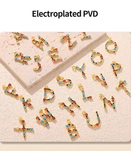Macro detail of A-Z copper pendants with colorful zircons and electroplated PVD gold finish