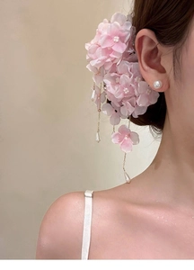 Detail of pink fabric flower hair clip with pearl tassels and shimmering petals